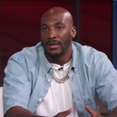 Aqib Talib is wearing a denim jacket with white tee and a chain.
